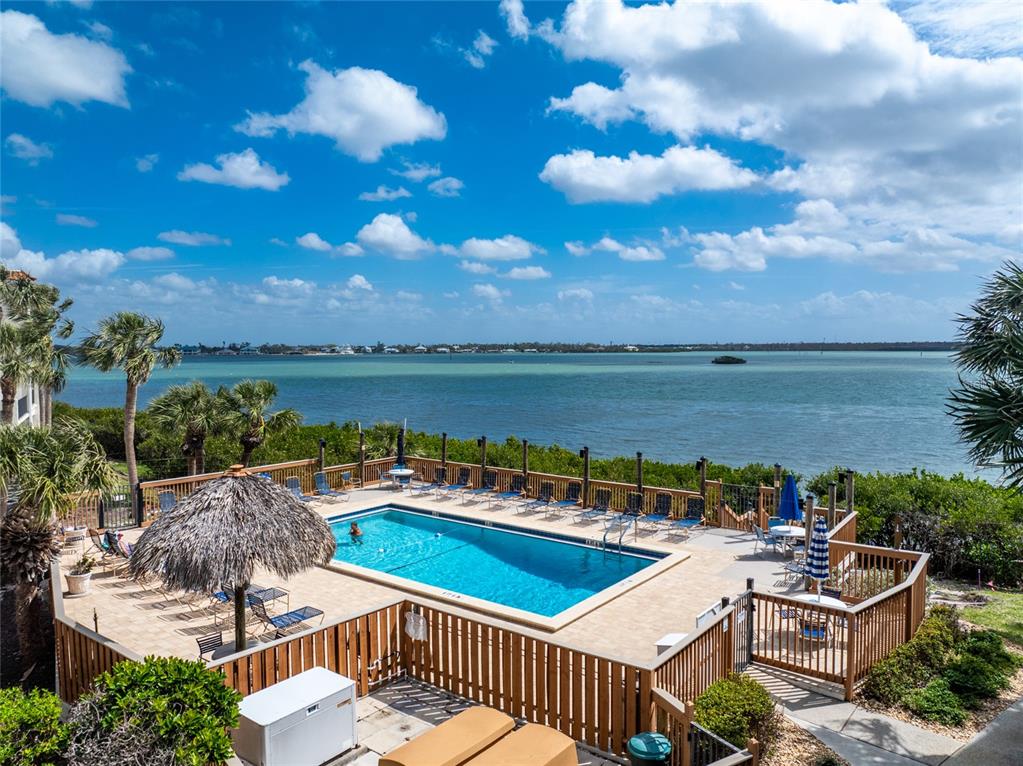 1551 Beach Road, Unit 306 Englewood, FL 34223 - Photo 3 of 50 a view of a swimming pool with lounge chairs