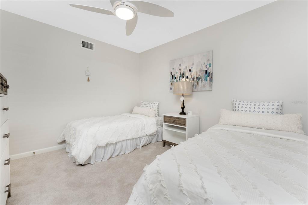 1551 Beach Road, Unit 306 Englewood, FL 34223 - Photo 33 of 50 a bedroom with a bed and a painting on the wall