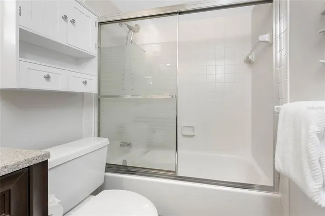 a bathroom with a shower and a toilet