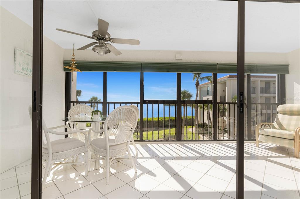 1551 Beach Road, Unit 306 Englewood, FL 34223 - Photo 36 of 50 a living room with a floor to ceiling window and a table