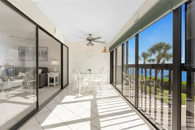 a view of a balcony with wooden floor and furniture