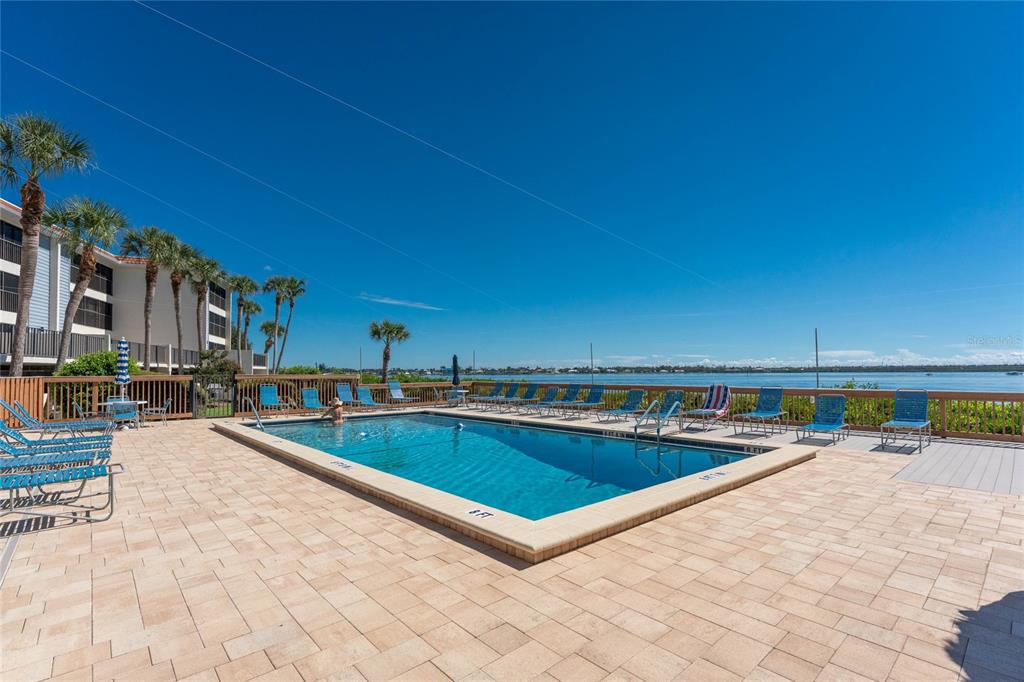 1551 Beach Road, Unit 306 Englewood, FL 34223 - Photo 41 of 50 a view of a swimming pool with a lounge chair
