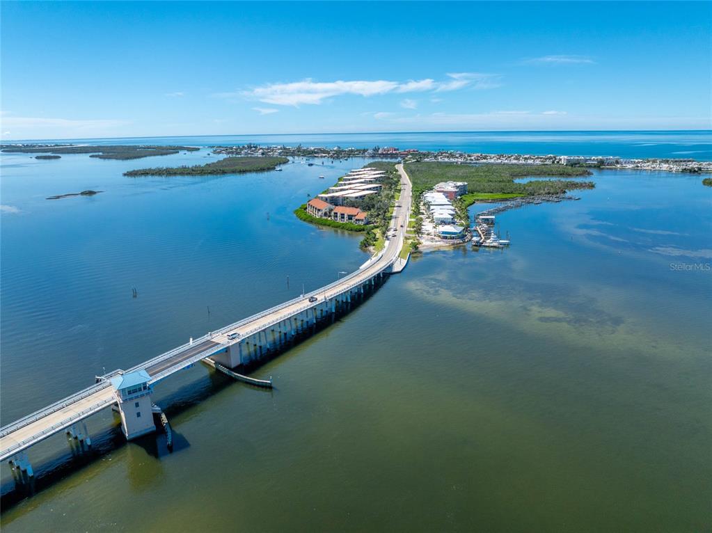 1551 Beach Road, Unit 306 Englewood, FL 34223 - Photo 43 of 50 an ocean beach with an outdoor seating