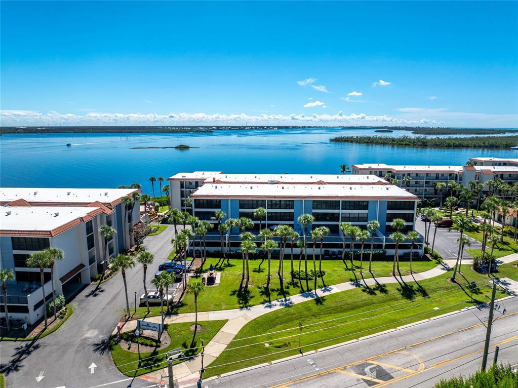1551 Beach Road, Unit 306 Englewood, FL 34223 - Photo 48 of 50 a view of a swimming pool with an outdoor seating and a garden