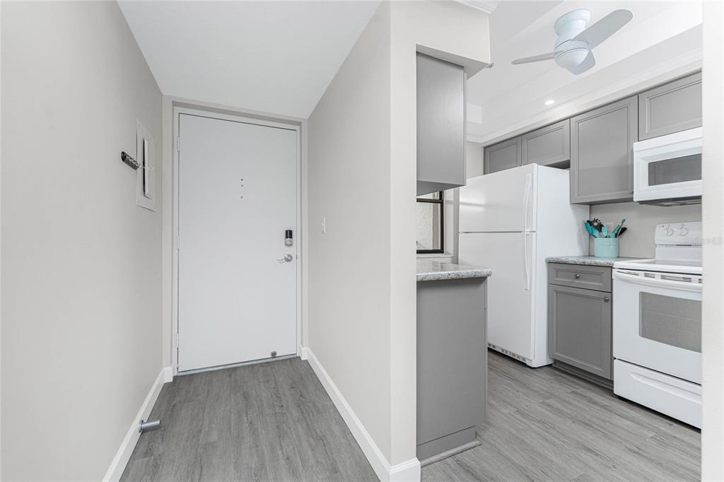 1551 Beach Road, Unit 306 Englewood, FL 34223 - Photo 8 of 50 a kitchen with stainless steel appliances a refrigerator and a stove top oven