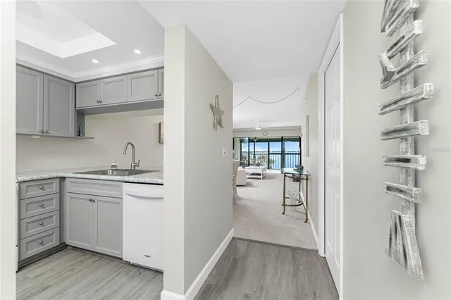 a kitchen with a refrigerator and white cabinets