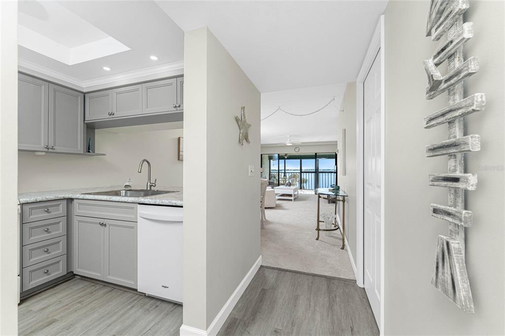 1551 Beach Road, Unit 306 Englewood, FL 34223 - Photo 9 of 50 a kitchen with a refrigerator and white cabinets
