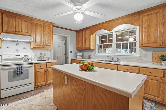 a kitchen with a sink stove and cabinets