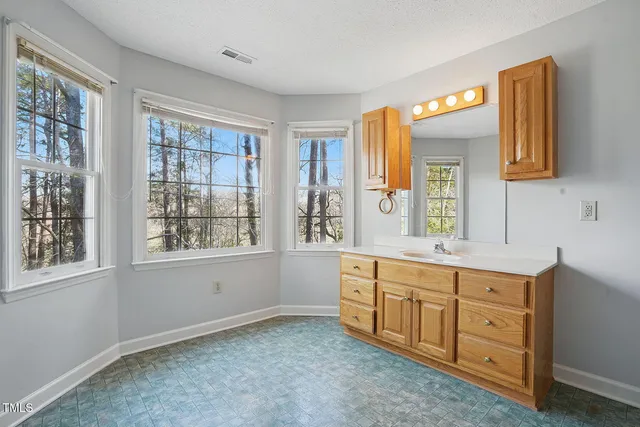 a spacious bathroom with a double vanity sink a mirror and a shower