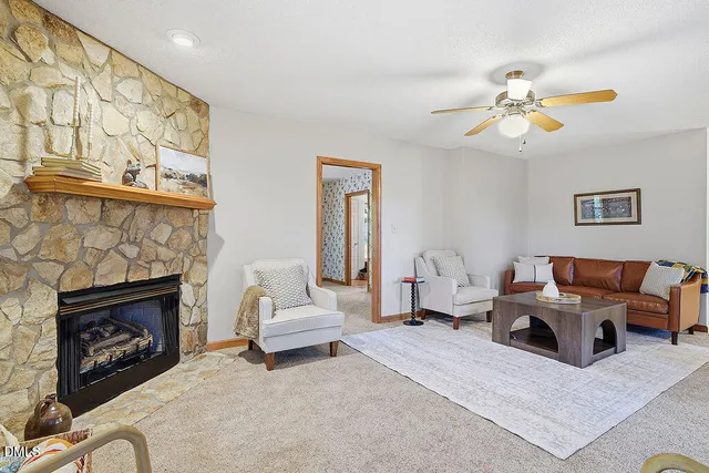 a living room with furniture and a large window with balcony view