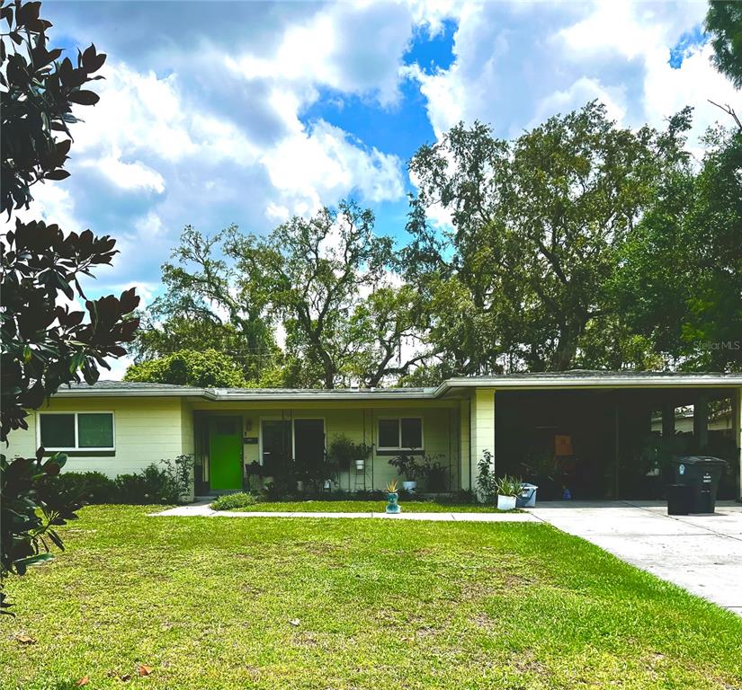 a backyard of a house with yard basket ball court and outdoor seating