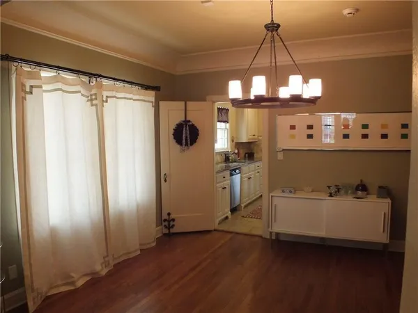 a view of a kitchen with a refrigerator and window