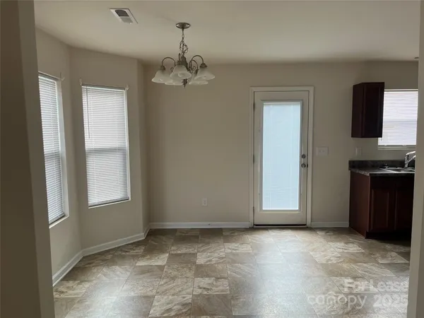 a kitchen with stainless steel appliances granite countertop a stove a refrigerator and a sink