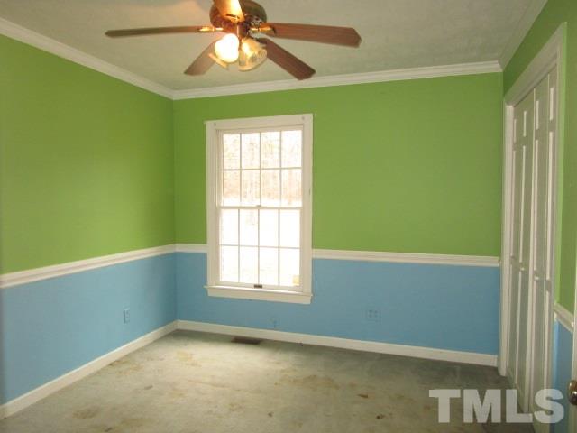 1307 Burlington Road Roxboro, NC 27573 - Photo 13 of 14 an empty room with windows and fan