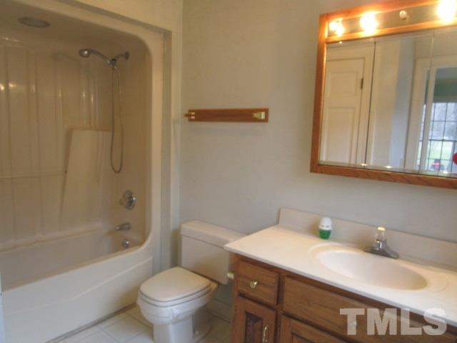 1307 Burlington Road Roxboro, NC 27573 - Photo 14 of 14 a bathroom with a granite countertop sink toilet and shower