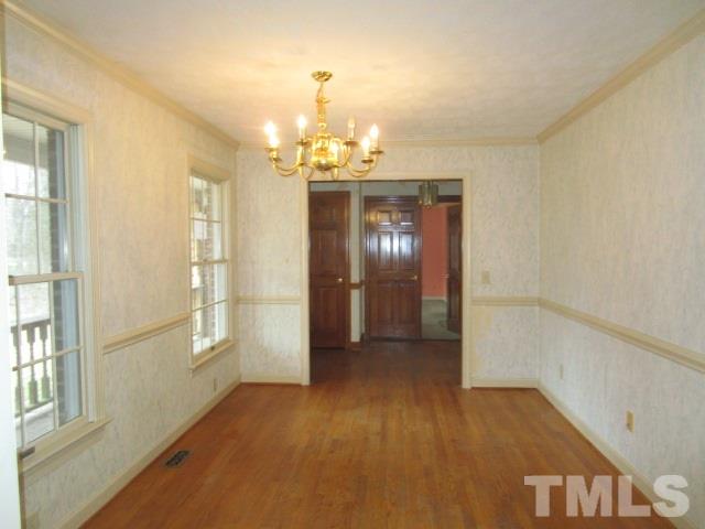 1307 Burlington Road Roxboro, NC 27573 - Photo 5 of 14 wooden floor in an empty room with a window