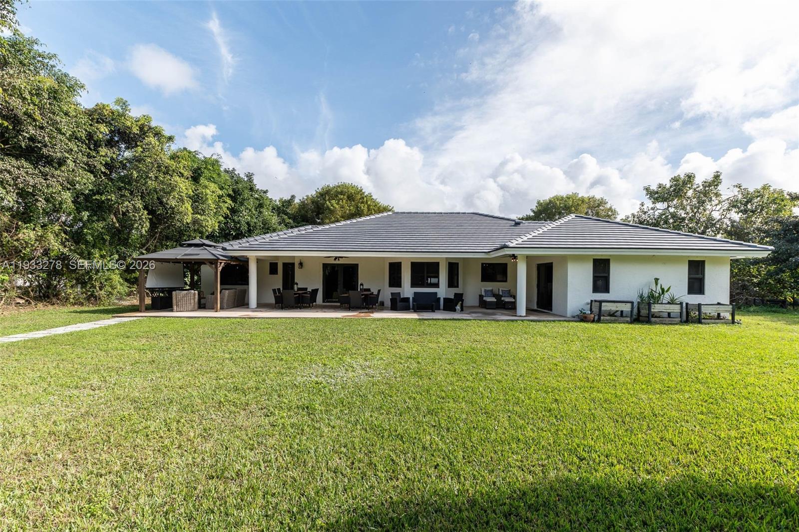 27260 Southwest 167th Court Homestead, FL 33031 - Photo 1 of 44 a front view of a house with garden