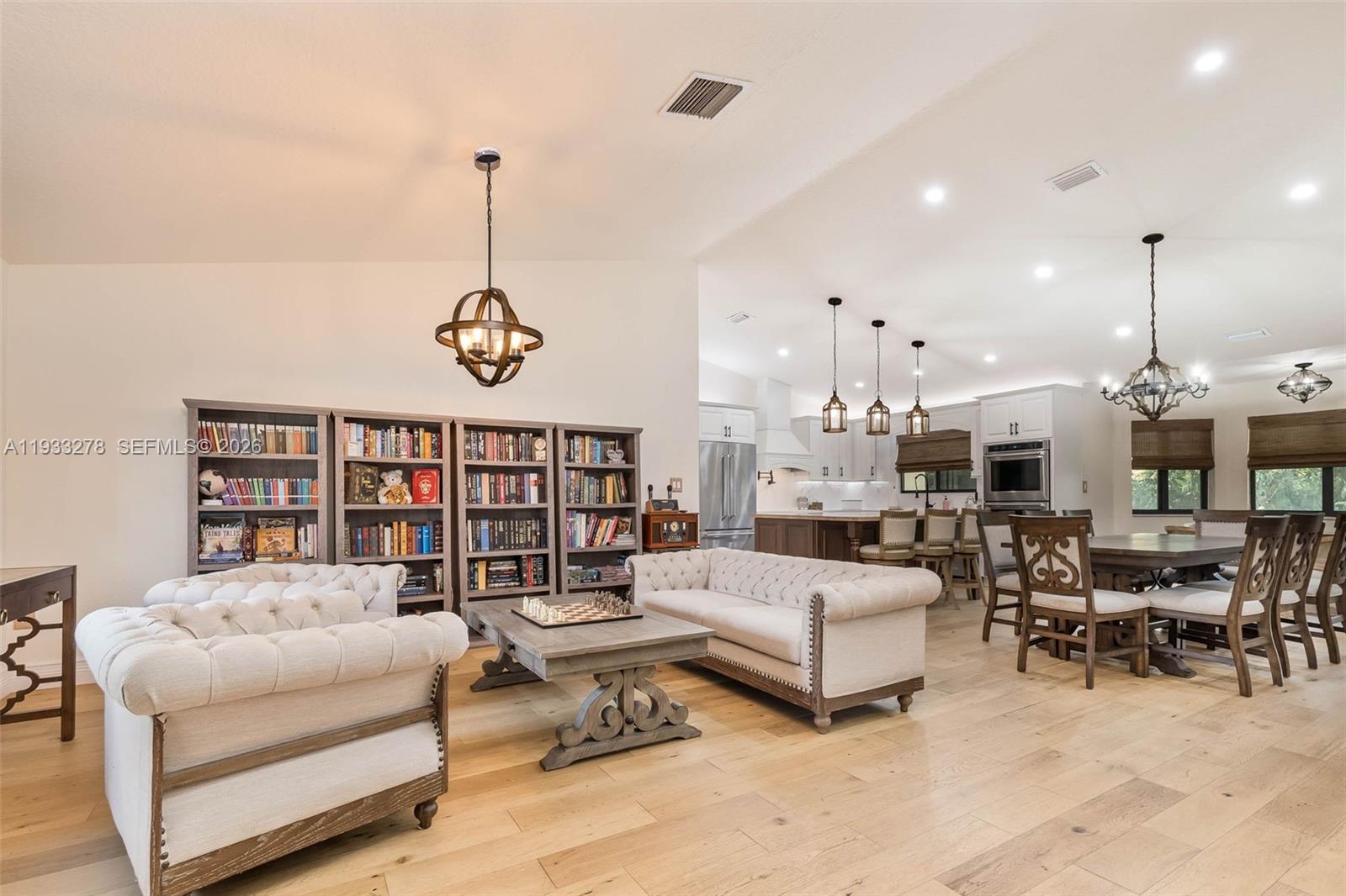 27260 Southwest 167th Court Homestead, FL 33031 - Photo 19 of 44 a living room with furniture kitchen view and a chandelier