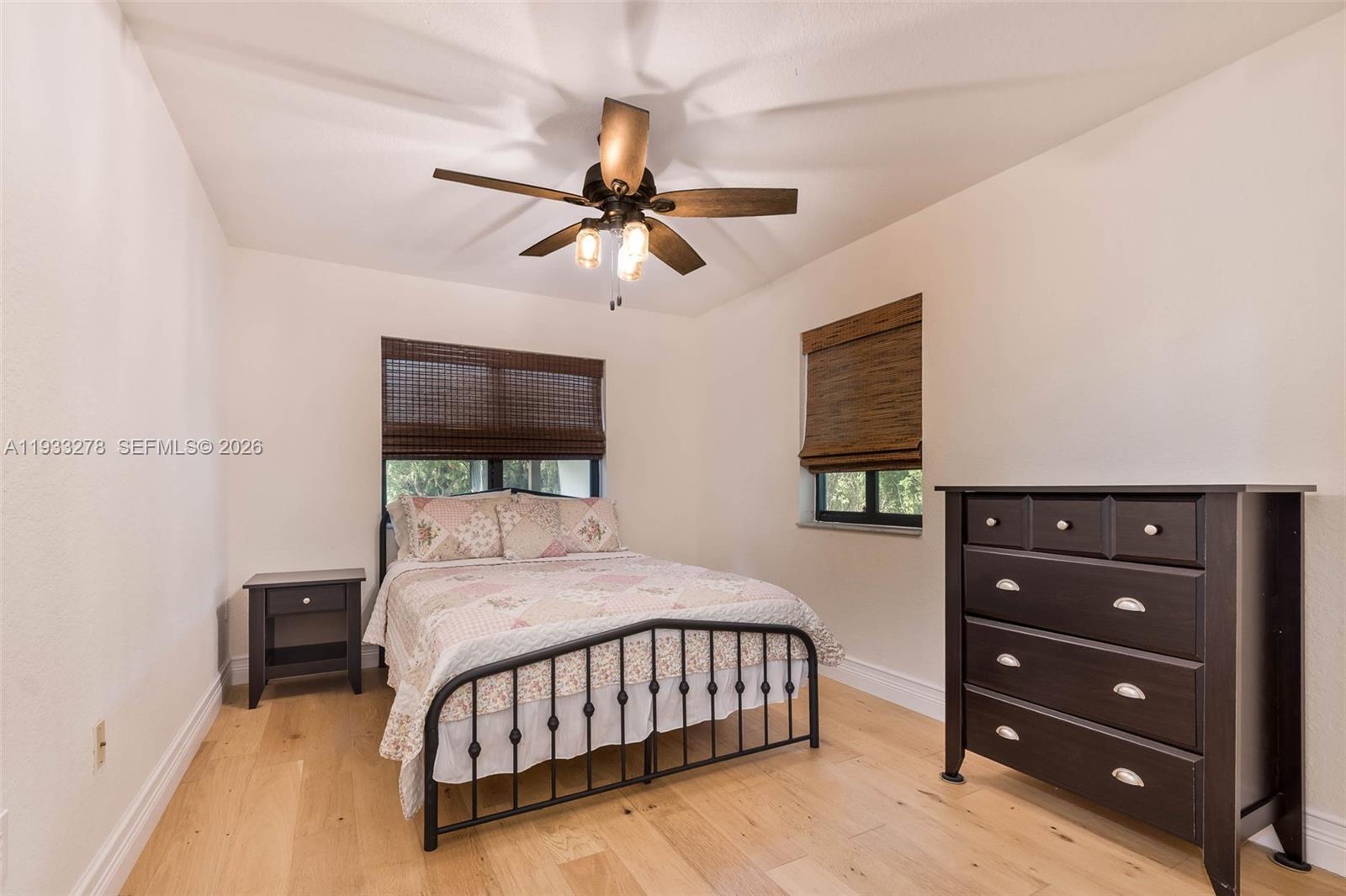 27260 Southwest 167th Court Homestead, FL 33031 - Photo 21 of 44 a bedroom with a bed a window and a chandelier