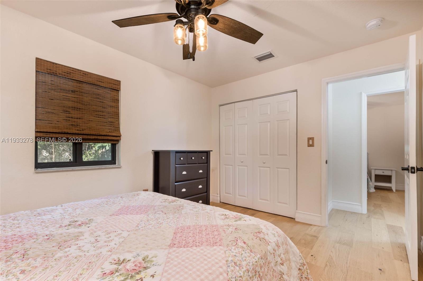 27260 Southwest 167th Court Homestead, FL 33031 - Photo 22 of 44 a bedroom with a bed and a chandelier