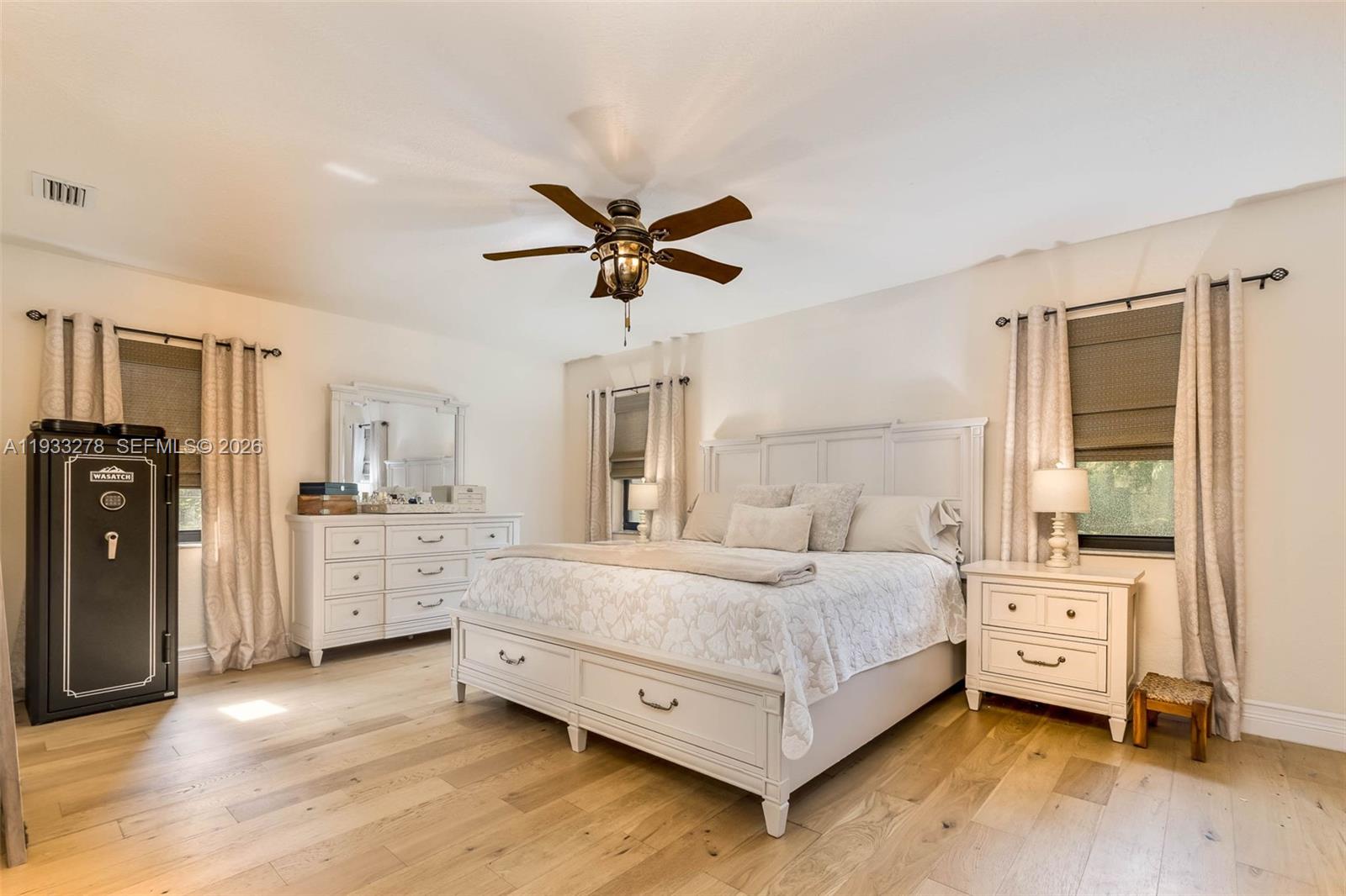 27260 Southwest 167th Court Homestead, FL 33031 - Photo 30 of 44 a bedroom with a bed and a chandelier