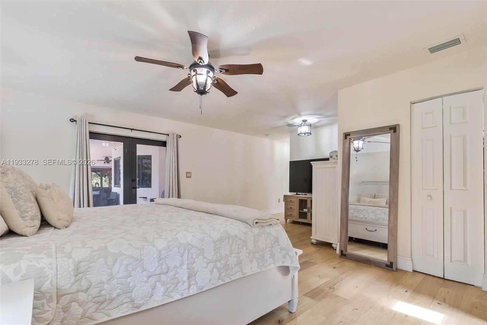 27260 Southwest 167th Court Homestead, FL 33031 - Photo 32 of 44 a bedroom with a bed and a chandelier