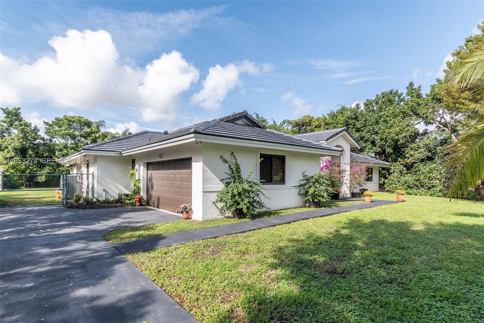 27260 Southwest 167th Court Homestead, FL 33031 - Photo 6 of 44 a view of a house with a yard and potted plants