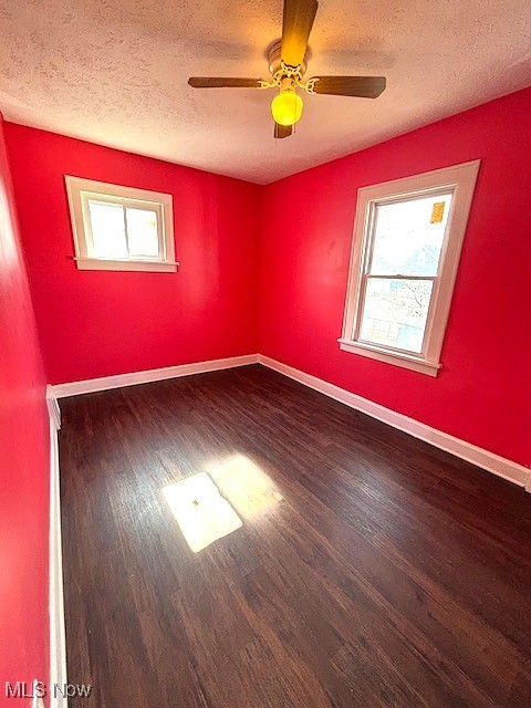 932 Nela View Road Cleveland Heights, OH 44112 - Photo 3 of 8 Empty room with plenty of natural light, wood finished floors, and baseboards