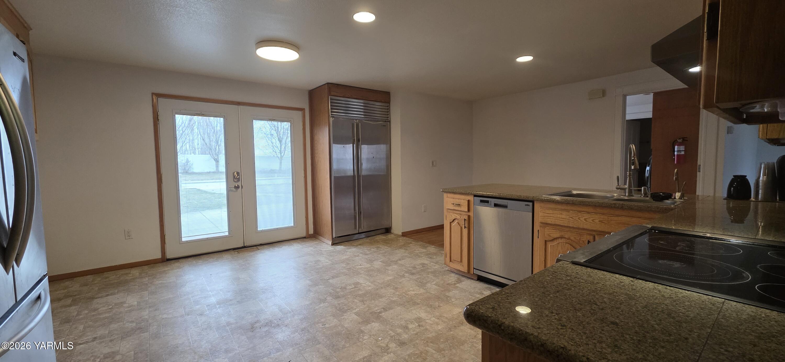 8601 Scenic Drive Yakima, WA 98908 - Photo 5 of 52 an empty room with wooden floor and entrance