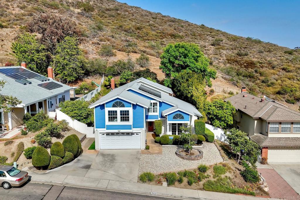 13639 Freeport Road San Diego, CA 92129 - Photo 30 of 44 a front view of a house with a garden