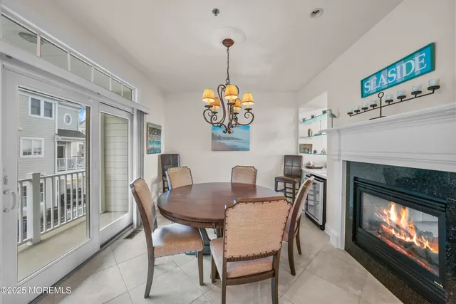 a dining room with furniture a chandelier and wooden floor