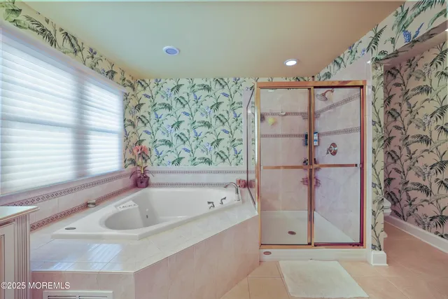 a bathroom with a bathtub and shower