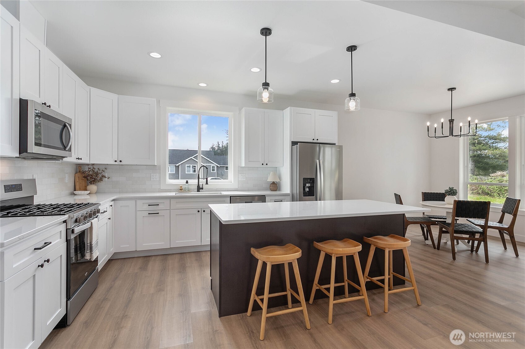 412 West 4th Street Everson, WA 98247 - Photo 12 of 31 a kitchen with stainless steel appliances granite countertop a dining table chairs stove refrigerator and cabinets