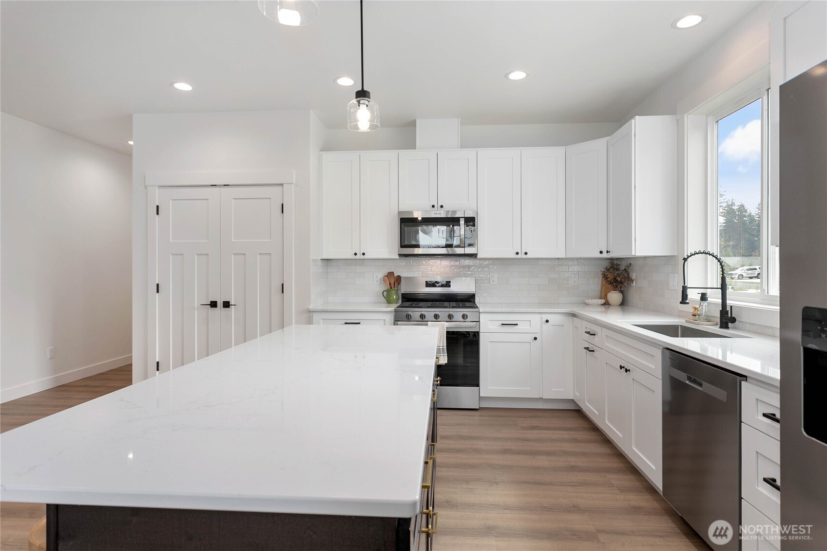 412 West 4th Street Everson, WA 98247 - Photo 16 of 31 a kitchen with granite countertop white cabinets and white appliances
