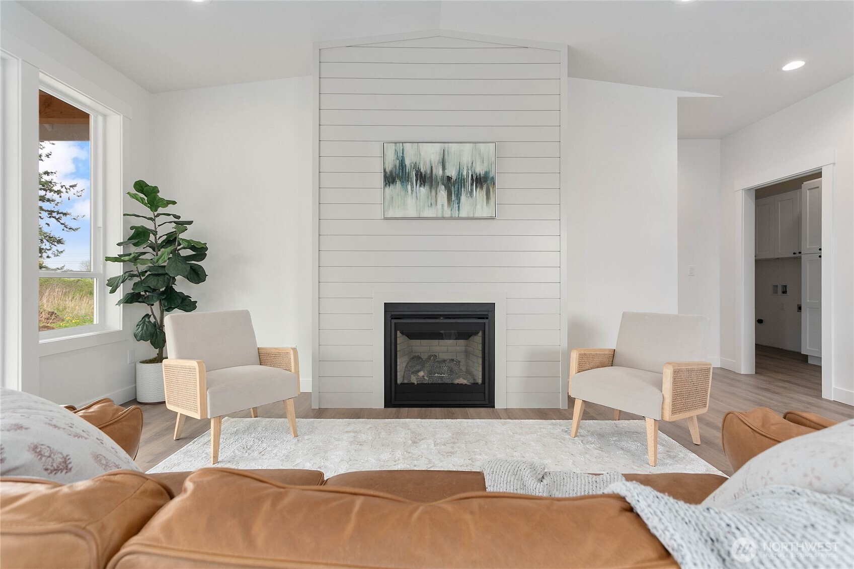 412 West 4th Street Everson, WA 98247 - Photo 23 of 31 a living room with furniture a fireplace and a potted plant