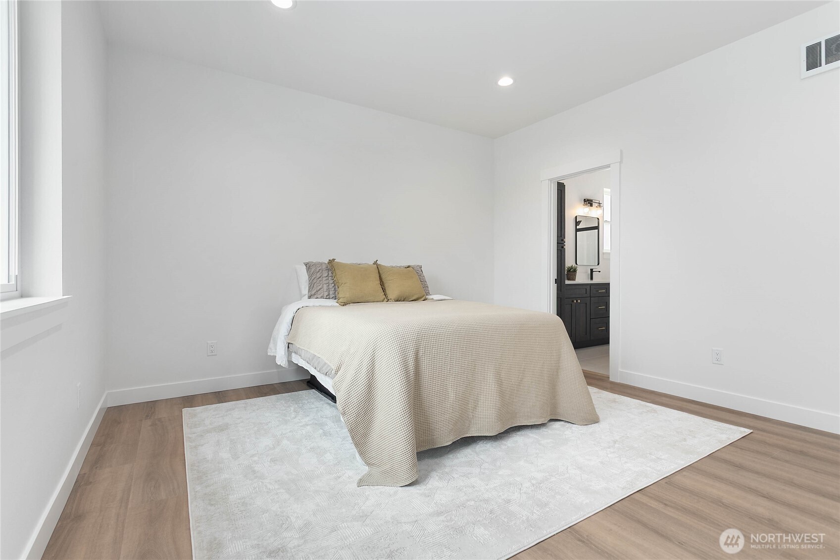 412 West 4th Street Everson, WA 98247 - Photo 28 of 31 a bedroom with a bed and wooden floor