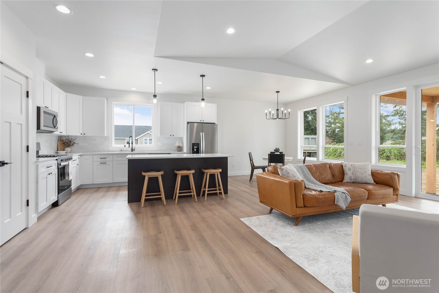 412 West 4th Street Everson, WA 98247 - Photo 31 of 31 a living room with furniture and a dining table with wooden floor
