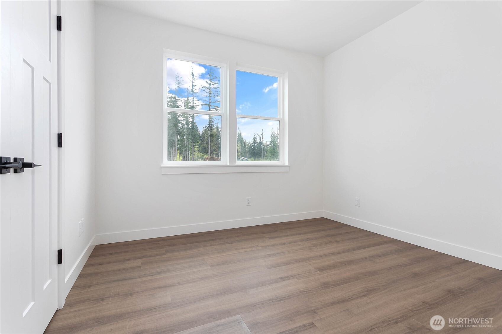 412 West 4th Street Everson, WA 98247 - Photo 9 of 31 a view of an empty room with wooden floor and a window