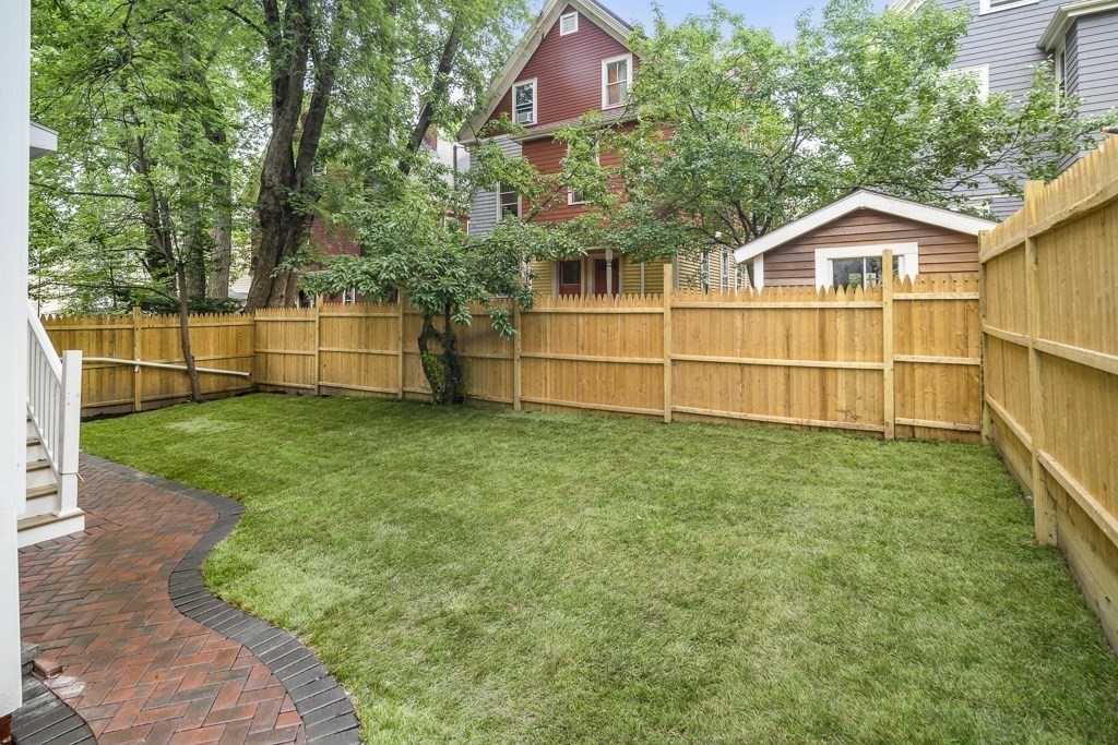 161 Lowell Street, Unit 1 Somerville, MA 02143 - Photo 15 of 18 a view of a house with a yard and sitting area