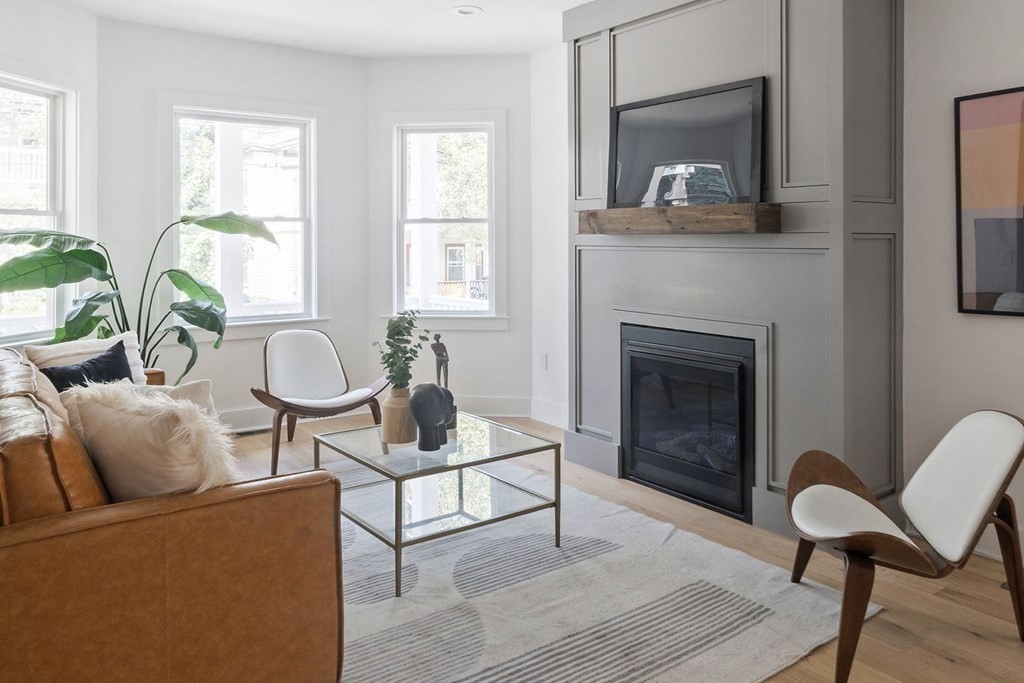 161 Lowell Street, Unit 1 Somerville, MA 02143 - Photo 3 of 18 a living room with furniture and a fireplace