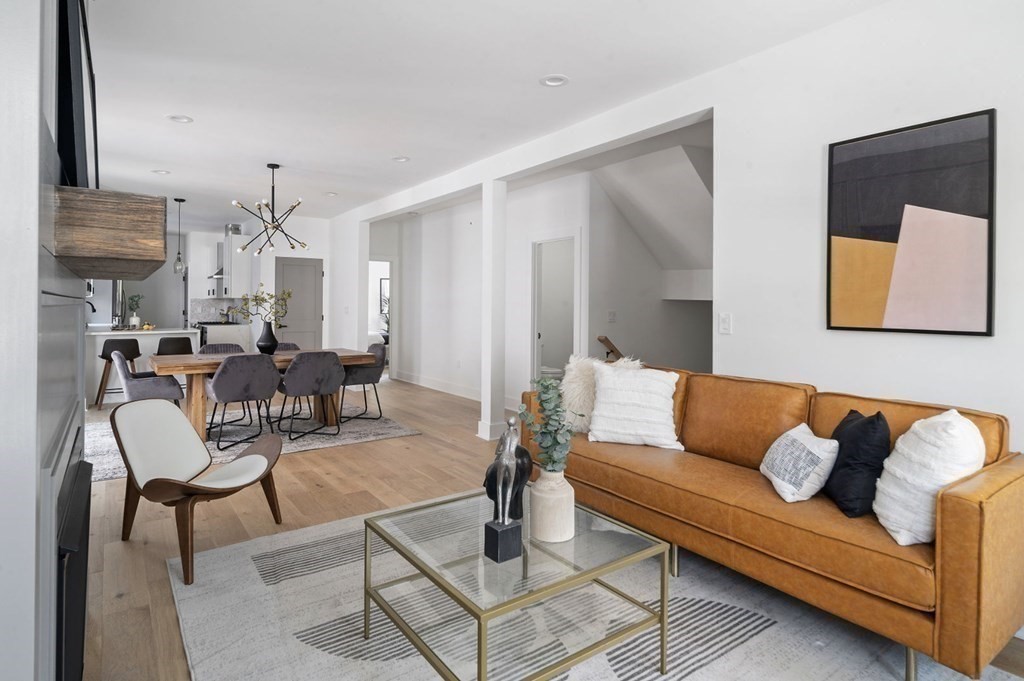 161 Lowell Street, Unit 1 Somerville, MA 02143 - Photo 4 of 18 a living room with furniture and a chandelier