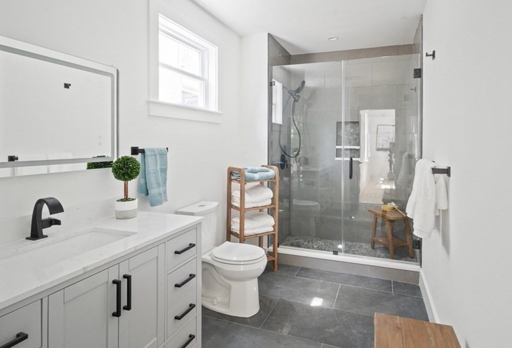 161 Lowell Street, Unit 1 Somerville, MA 02143 - Photo 7 of 18 a bathroom with a shower sink and toilet