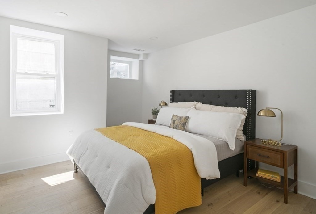 161 Lowell Street, Unit 1 Somerville, MA 02143 - Photo 10 of 18 a bedroom with a bed and a window