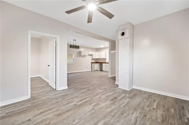 a view of a livingroom with a furniture wooden floor and a ceiling fan