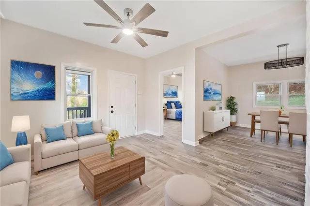 a living room with furniture and wooden floor