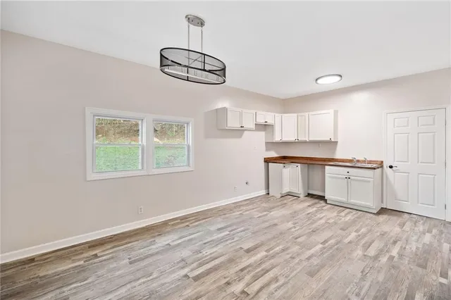 a kitchen with stainless steel appliances kitchen island a refrigerator and a stove top oven