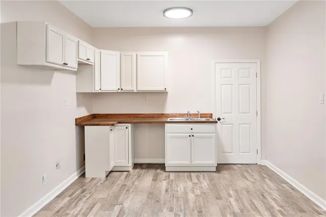 a view of kitchen with granite countertop cabinets and sink