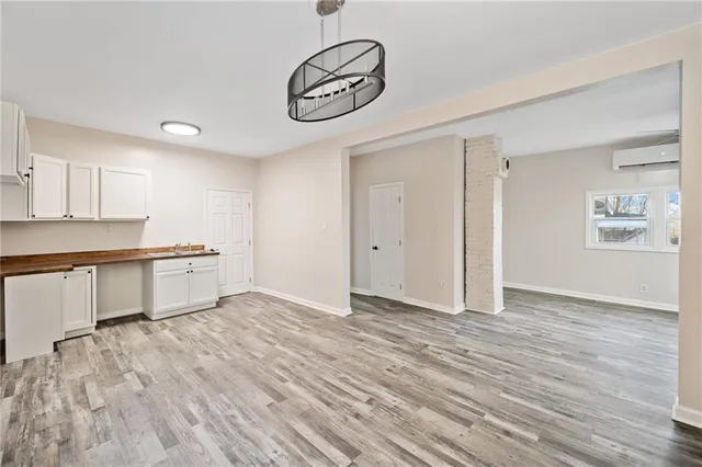 a view of a kitchen with wooden floor and a sink