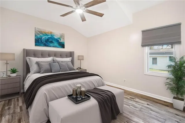 an empty room with a window and a ceiling fan