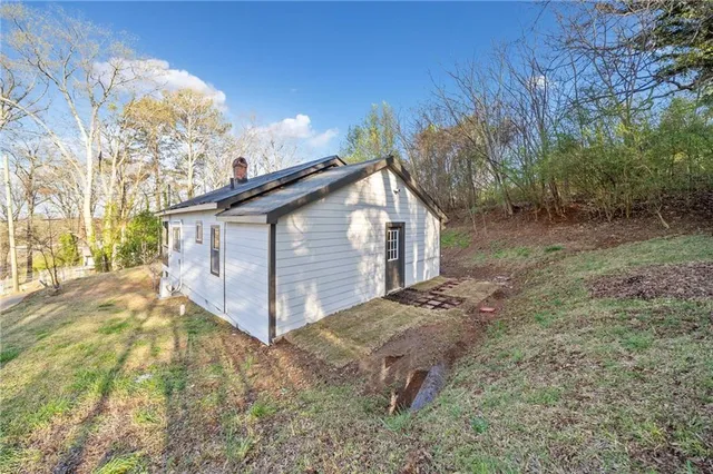 a view of a backyard with large trees